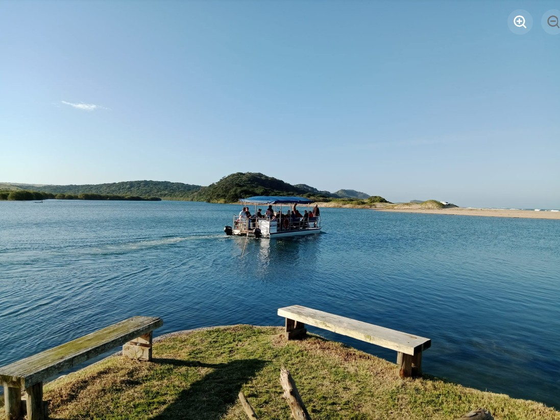 Barge drifting along the calm Nxaxo River